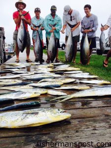 Harris Sloane and friends from Charlotte, NC, with yellowfin tuna and dolphin they hooked while trolling offshore of Oregon Inlet with Capt. Dave Peck and mate Jason Sadler out of the Oregon Inlet Fishing Center.