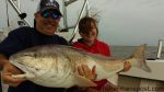 David and Jessica Buchanan with a 49" red drum they caught and released in the Pamlico River after it struck an artificial while they were fishing with Capt. Mitchell Blake of FishIBX.com.