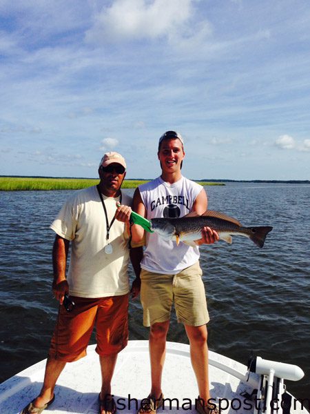 Dwayne Smith and Tyler Bradsher, of Cary NC, with a slot red drum Bradsher caught in a Morehead-area marsh after it struck a Salty Bay Baits Red Devil spinnerbait.