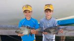 Thad and Seth Moye with a pair of triggerfish they hooked on cut baits while bottom fishing off Beaufort Inlet.