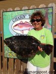 Rachel Morgan, of Beaufort, NC, with a 7.23 lb. flounder that bit a live fiddler crab near the Morehead port wall. Weighed in at Chasin' Tails Outdoors.