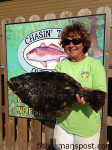 Rachel Morgan, of Beaufort, NC, with a 7.23 lb. flounder that bit a live fiddler crab near the Morehead port wall. Weighed in at Chasin' Tails Outdoors.