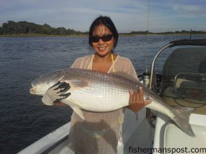 Evelyn Berry, of Richlands, NC, with a 48" red drum she caught and released near Browns Inlet after it struck a pigfish on a Carolina rig.