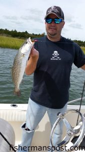 Mike Larson, of Wilmington, with a 20" speckled trout that bit a soft plastic bait near Browns Inlet.