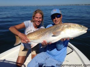 Mary Jane Measmer, of China Grove, NC, and Tim Corn with a citation red drum she hooked on a live menhaden at Yaupon Reef. The fish was released after the photo.