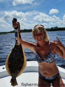 Vicki Boyd, of Wilmington, with a 4.6 lb. flounder that struck a live finger mullet in the Cape Fear River near Southport.