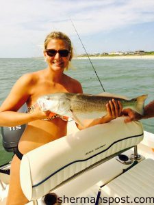 Chelsea Frey, of Stem, NC, with a 26.75" red drum that bit a live finger mullet just off Atlantic Beach.