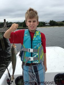 John Daniel Griffin with a 17" speckled trout he hooked in Carolina Beach Inlet while fishing with family.