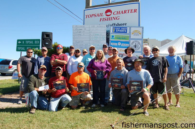 The winners of the Topsail Island Fall Surf Fishing Challenge with their prize money and plaques following the end of the 36-hour fishing marathon headquartered at Surf City’s East Coast Sports.