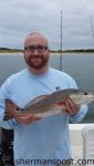 Troy McGuire with a red drum he hooked on a Carolina-rigged finger mullet inshore of North Topsail Beach.