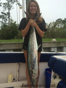 Katie Speed, of Cape Carteret, with a 28  lb. king mackerel she landed 2 miles off Bardens Inlet while fishing on the "Ally-Reb." A live menhaden fooled the king.