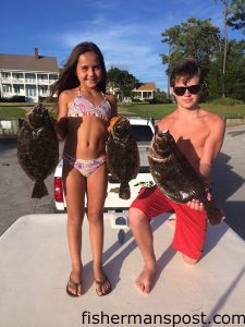 Macy Wojciechowski (age 8) and Patrick Harrell (age 14) with flounder that bit live finger mullet near AR-315.