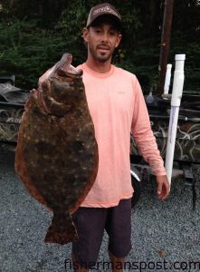 Chris McDougald, of Burgaw, with a 7 lb., 11 oz., 25" flounder that struck a live finger mullet in Snows Cut.