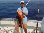 Sherry Hunt, of Charlotte, with a red grouper that bit a live tomtate at some live bottom 40 miles off Carolina Beach while she was fishing with Capt. Tom Sayre on "The Mate."