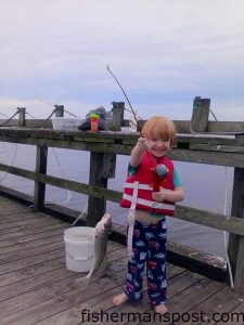 Dahlton Sapp (age 3), of Wilmington, with his first croaker, hooked on a piece of squid near Carolina Beach Inlet.