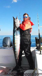 Tommy Scheetz with a 59 lb. wahoo that bit a skirted ballyhoo near the Steeples while he was fishing with Capt. Wally Trayah of Oak Island Fishing Charters.