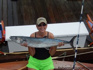 Sheila Hill, of Denver, CO, with her first king mackerel, hooked on a ballyhoo behind a black/purple sea witch while she was trolling near Frying Pan Tower on the "ANNALI."