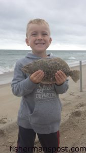 Baylor Harris (age 6), of Burgaw, NC, with his first flounder, hooked on a piece of squid in the Fort Fisher surf.