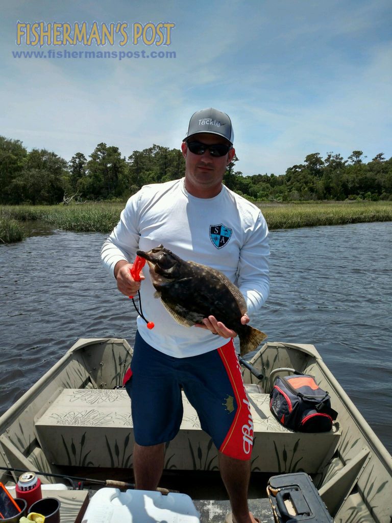 T.C. Smith with a 19.5" flounder that struck a live mud minnow in Bald Head Creek while he was fishing with Jordan Frye.