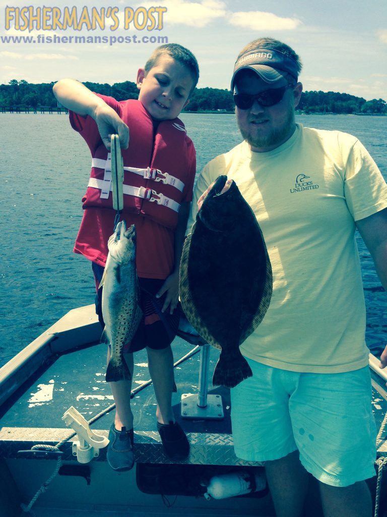 Hunter and Trey Cain, of Wilmington, with a speckled trout and a flounder that struck live menhaden in Snow's Cut.