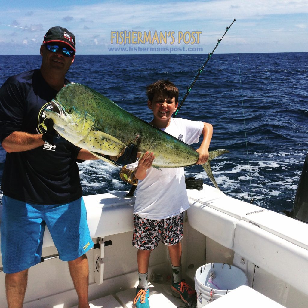 Patrick Horning and Shane Kerrigan Bigoness (age 11) with Shane's first dolphin, a 35 lb. fish that he landed after it attacked a ballyhoo near the Steeples while they were trolling on the "Bruiser."