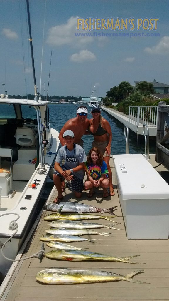 Coop Jackson, Tayna Grant,and Colby and Alexandra Jackson, with a big king mackerel and dolphin they hooked while trolling dead baits 18-20 miles off Wrightsville Beach with Capt. Lynn Perry of Shearwater Fishing Charters.