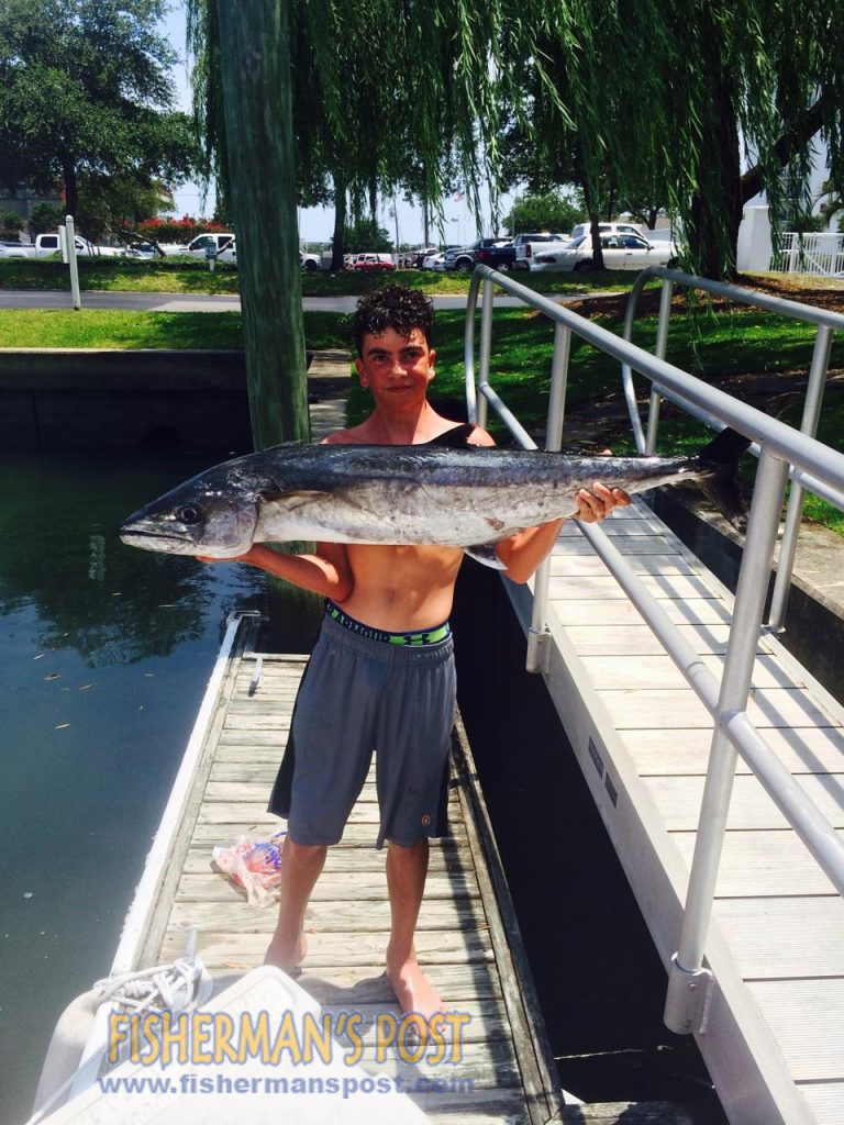 Tripp Evett (age 14) with a 29 lb. king mackerel he landed while fishing 30 miles off Wrightsville Beach with is father Gil and Zach Faircloth.