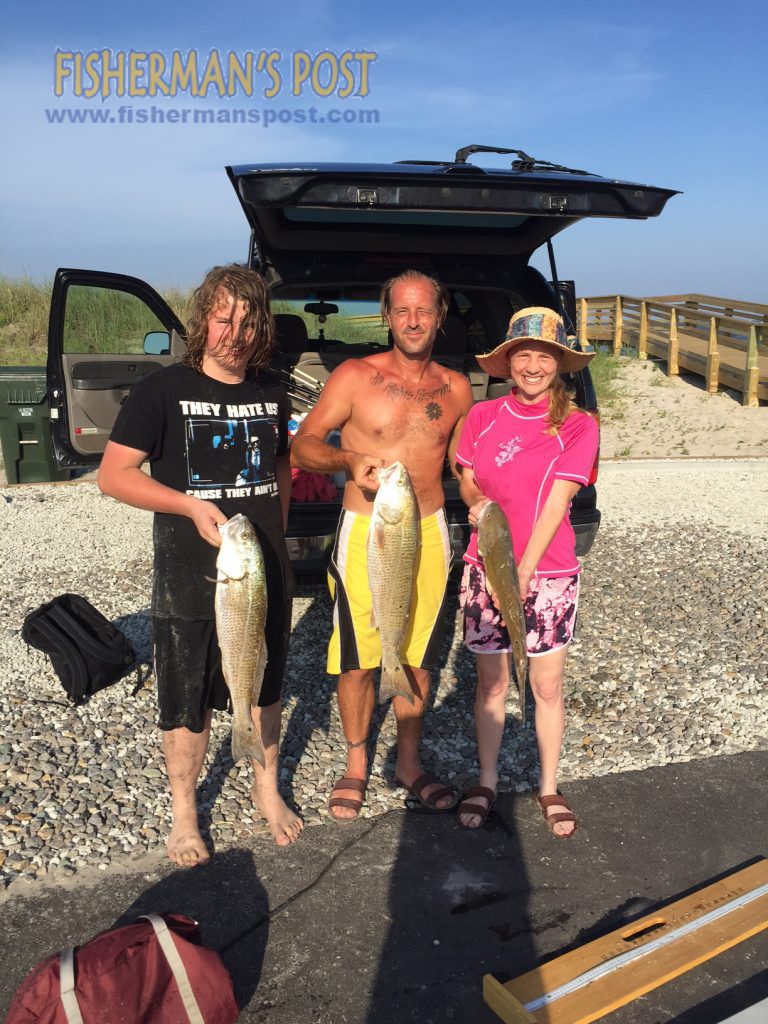 Travis, April, and Nathan Ashbrook with a trio of slot red drum they hooked on frozen menhaden in New Topsail Inlet.