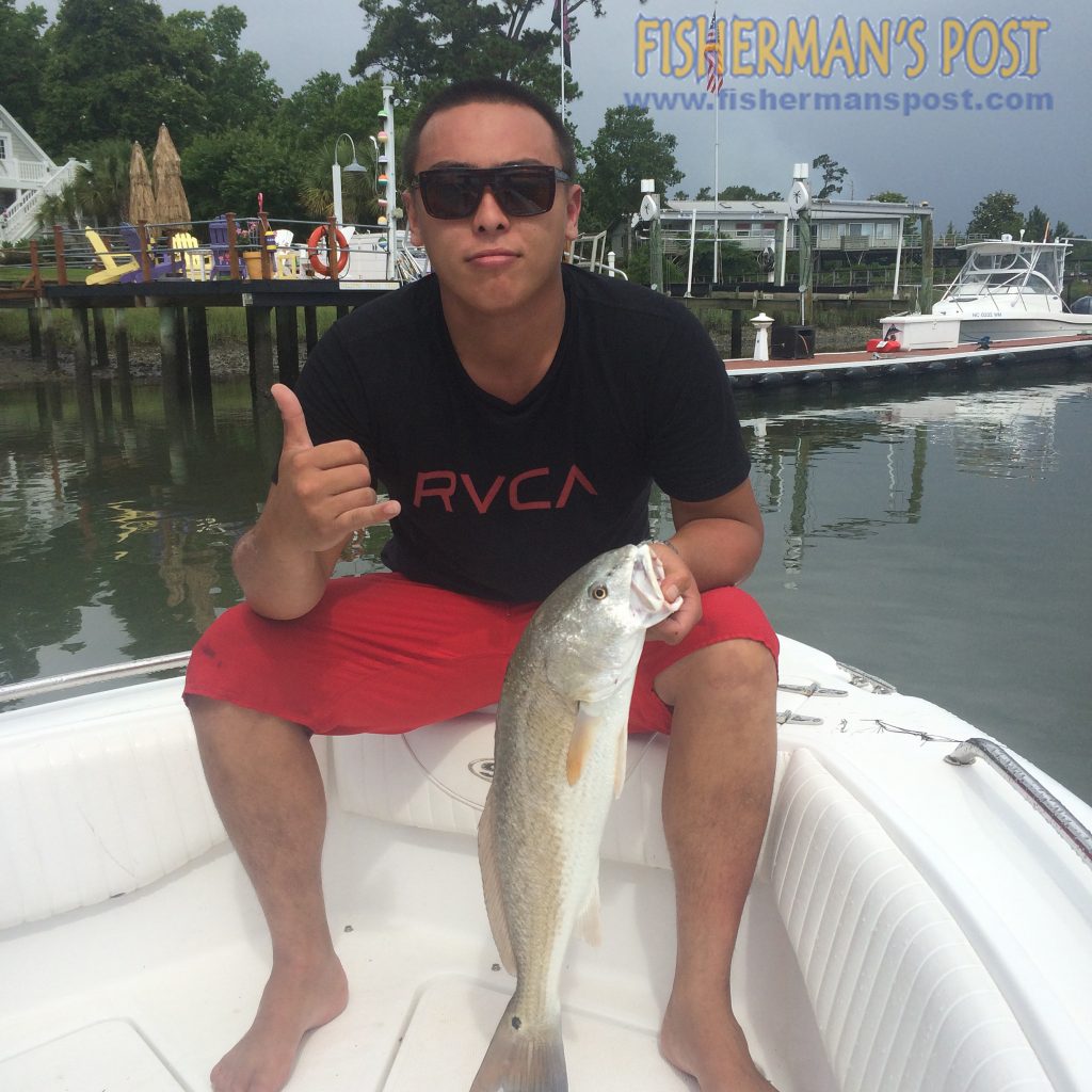 Jordan Racca with a 27" red drum he hooked on a live bait in Pages Creek.