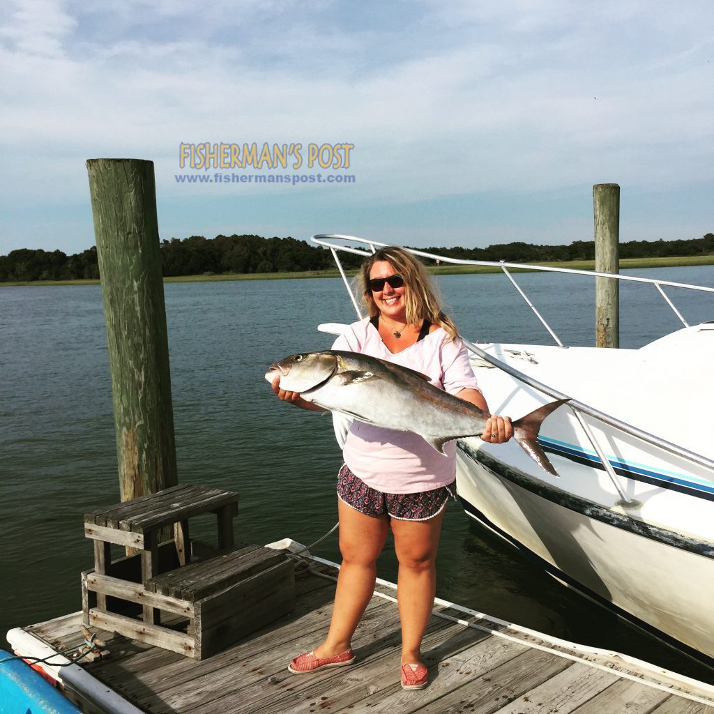 Fisherman's Post Layout Artist Sarah Gagliardo with her first amberjack. The 30 lb. fish fell for a live bait above a wreck in 100' of water off Lockwood Folly Inlet while she was fishing with Capt. Ryan Jordan of Fugitive.