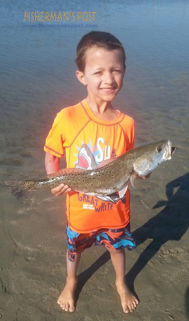 Erickson Webb (age 6), of Winnabow, NC, with his first speckled trout, hooked on a live finger mullet while he was fishing inshore at Sunset Beach with his father.