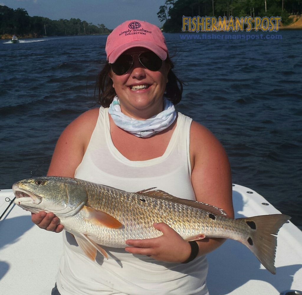 Ashley Duncan, of Huntington, WV, with an over-slot red drum that bit a large finger mullet in Snow's Cut while she was fishing with Capt. Charlie Schoonmaker of Back Bay Fishing Charters.