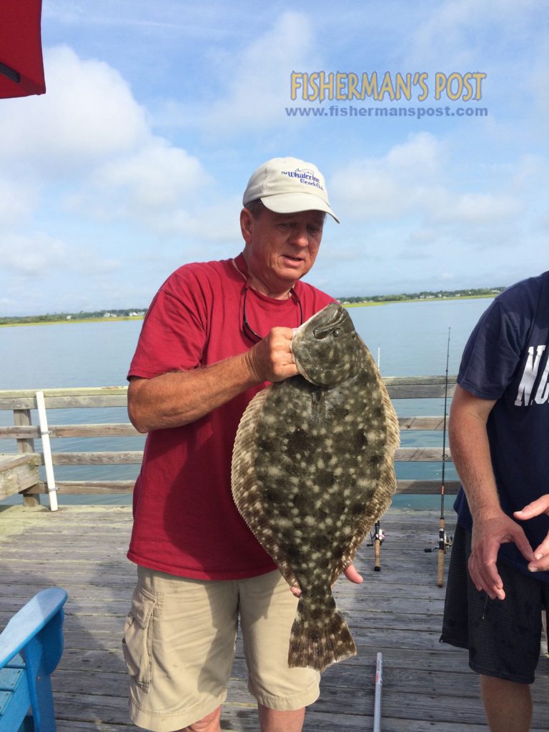 Mickey Love with a 7.3 lb. flounder that he hooked on a Topsail Beach dock. Weighed in at East Coast Sports.