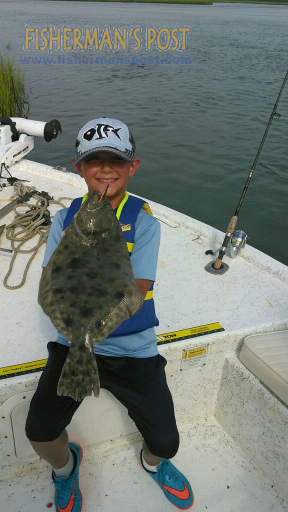 Luke Humphreys, of Raleigh, with a flounder that attacked a live finger mullet while he was fishing in Tubbs Inlet with Capt. Jeff Williamson of Get Busy Charters.