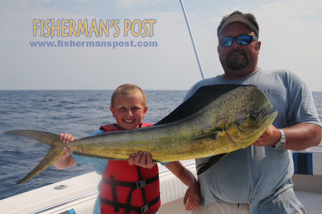 Jake Holmes (age 11), and Ken Broomfield, with a dolphin that Jake landed while trolling 18 miles off Topsail Island on the "Fish Hooker."