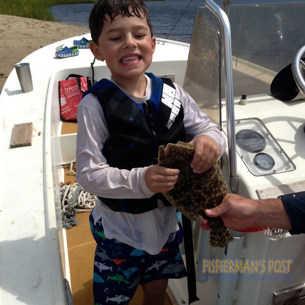 Braxton Alexander, of Fayetteville, NC, with a flounder that bit a live finger mulletin the Cape Fear River while he was fishing with his cousins.