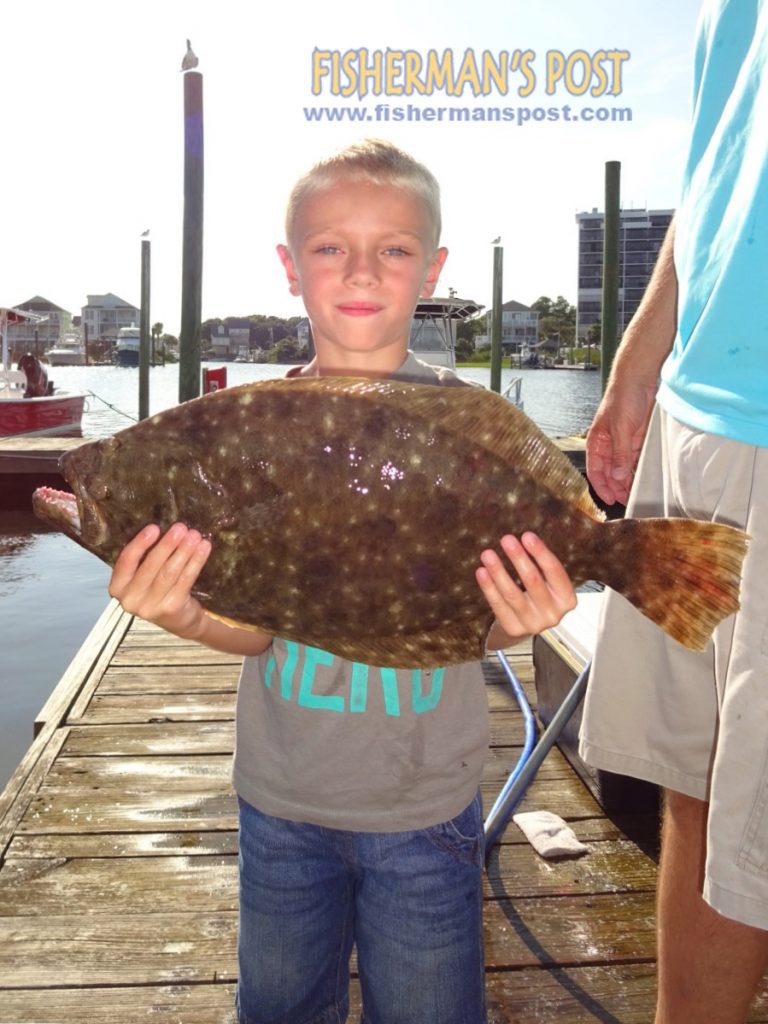 Caleb Hall, of Carolina Beach, with a 21" flounder that bit a live finger mullet in the Cape Fear River.