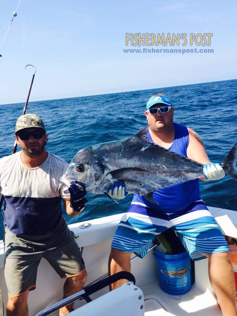 Capt. Erik Scheeler, of "Wide Open Charters," and Austin Wood with an African pompano that chased down a hooked sea bass while they were fishing at Frying Pan Tower.