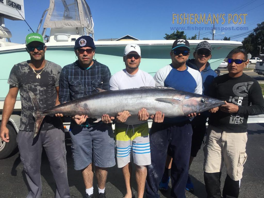 Felipe Balbino and the crew of the "Bigg Daddy" with a 98.2 lb. wahoo they landed after it attacked two king mackerel rigs while they were trolling 10 miles off Carolina Beach.