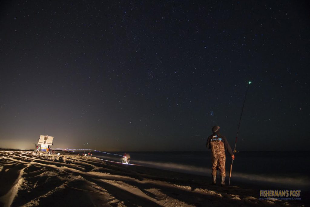 Michael Sing stands watch (hoping for a redfish bite) on Saturday night at the South End during the Pleasure Island Surf Fishing Challenge.