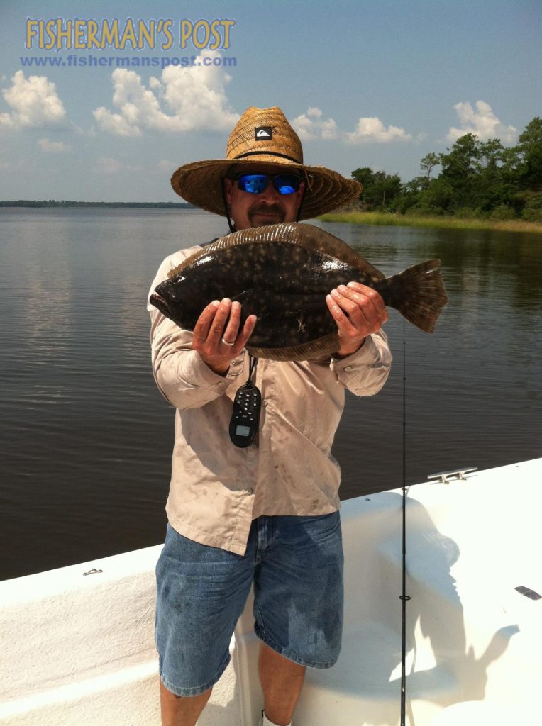 James Brooks, of Siler City, NC, with a 21" flounder that bit a soft plastic bait near a Cape Fear River dock.