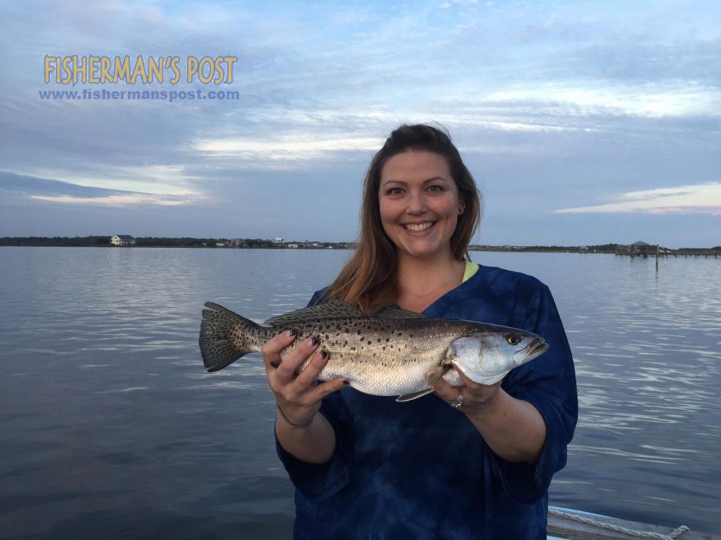 Tonya Jones with a speckled trout that she hooked on a topwater plug while fishing inshore of Topsail Island.