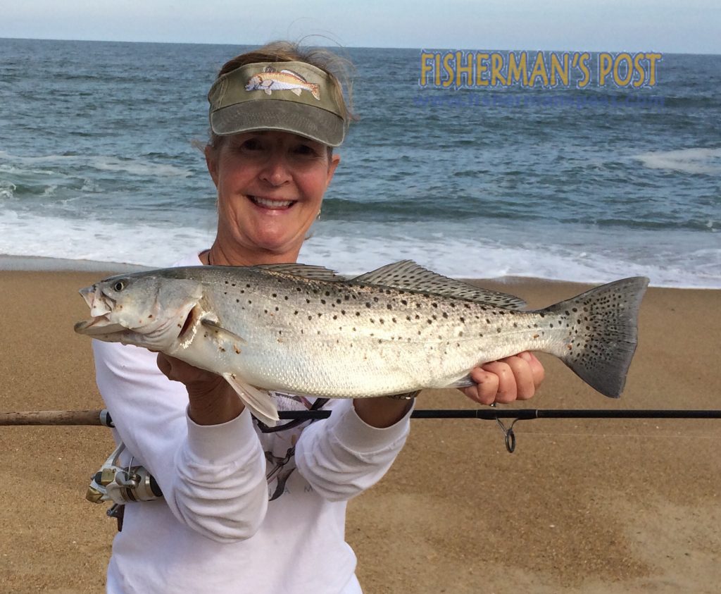 Linda Harper with a 22" speckled trout she hooked from the beach at Kill Devil Hills. Photo courtesy of TW's Tackle.