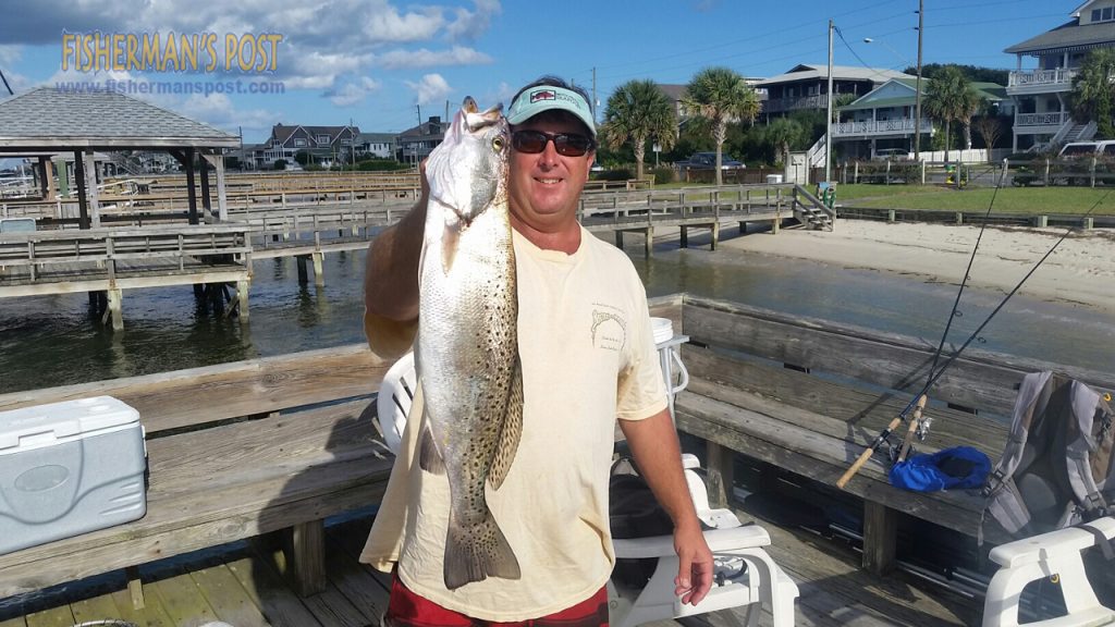 Steve Wright, of Wilmington, with a speckled trout that bit a live finger mullet in a creek near Masonboro Inlet.